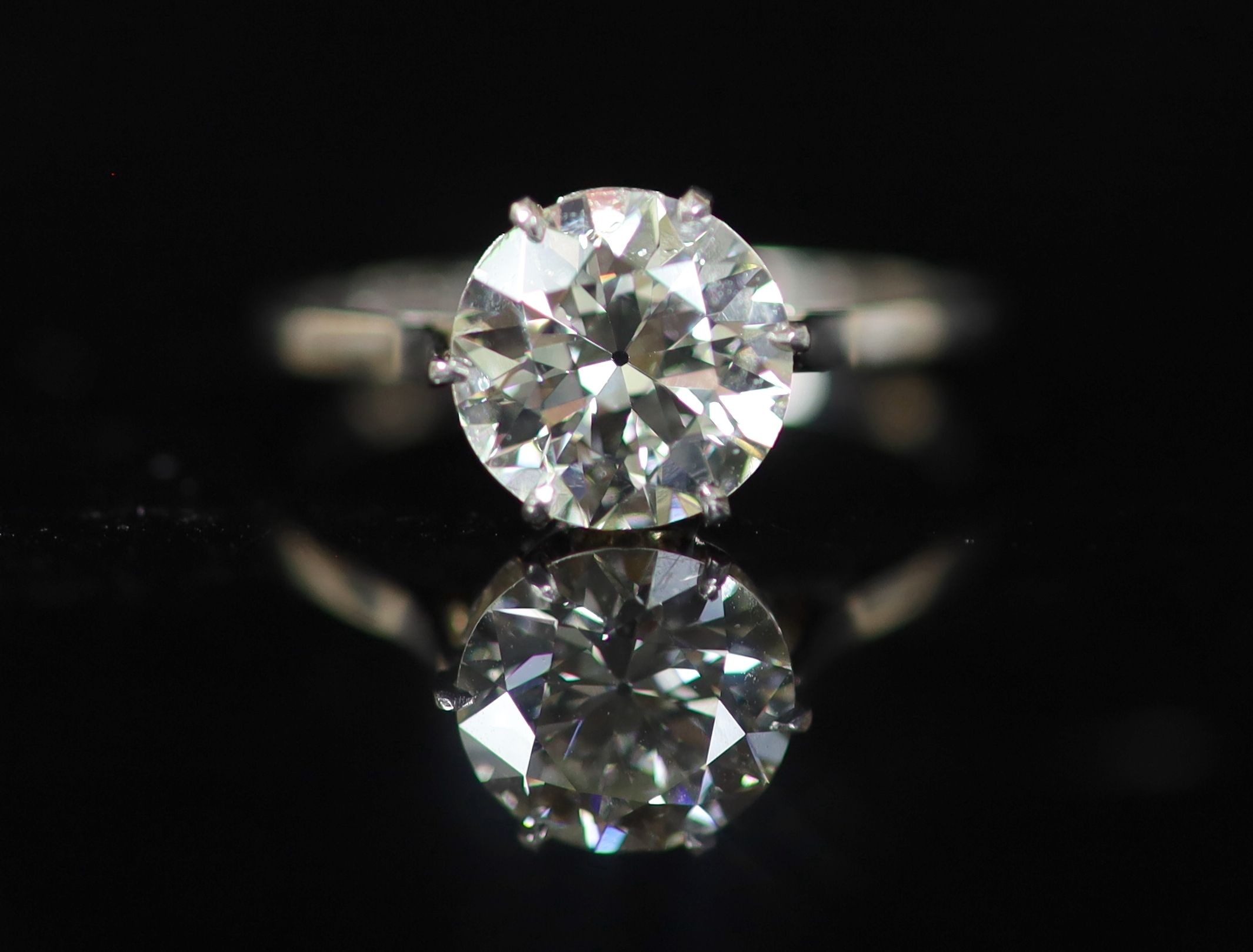 A platinum and solitaire diamond ring